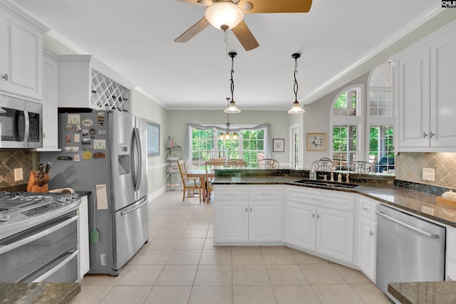 17 Laurel Bluff Ct, Columbia, SC 29229 - kitchen featuring appliances with stainless steel finishes, a sink, ornamental molding, white cabinets, and decorative backsplash