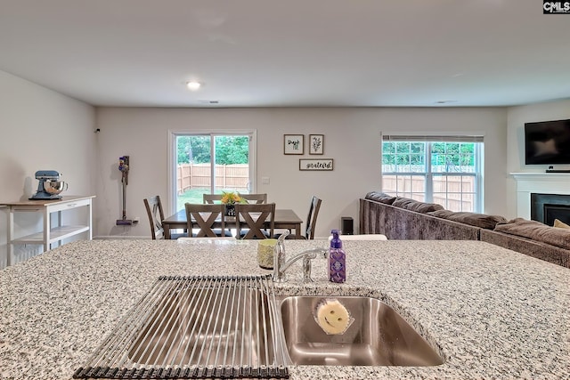 2040 Elmridge Rd, Columbia, SC 29209 - kitchen with light stone countertops, open floor plan, and a fireplace