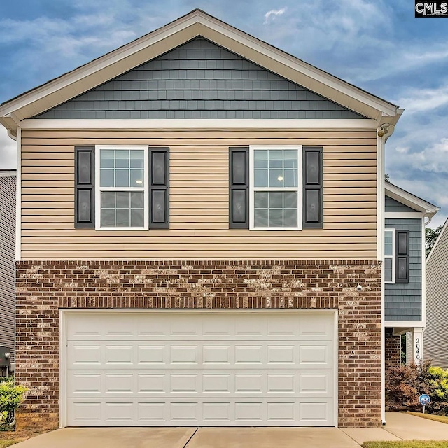 2040 Elmridge Rd, Columbia, SC 29209 - view of front of property featuring driveway, brick siding, and an attached garage