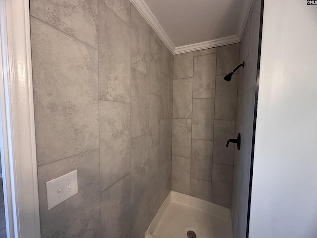 full bathroom featuring crown molding and a shower stall