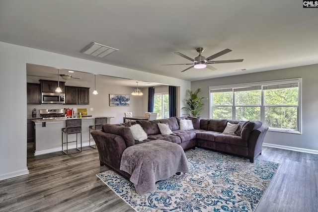 171 Turnfield Dr, West Columbia, SC 29170 - living area with dark wood finished floors, baseboards, a ceiling fan, and a chandelier