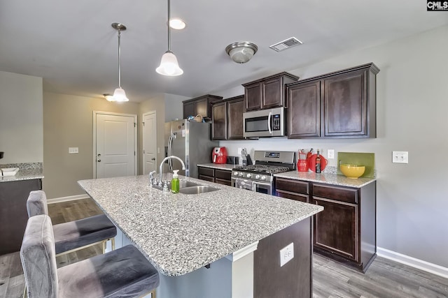 171 Turnfield Dr, West Columbia, SC 29170 - kitchen with appliances with stainless steel finishes, a sink, baseboards, and light wood-style floors