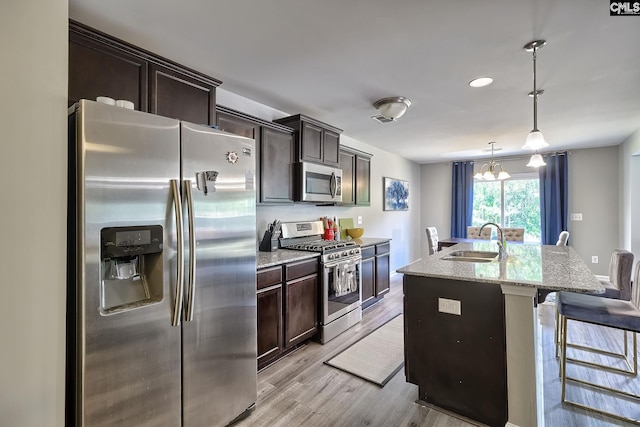 171 Turnfield Dr, West Columbia, SC 29170 - kitchen featuring appliances with stainless steel finishes, a sink, dark brown cabinetry, a kitchen breakfast bar, and recessed lighting