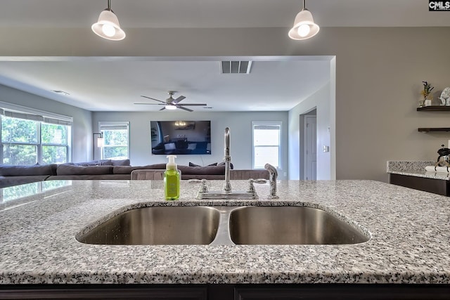 171 Turnfield Dr, West Columbia, SC 29170 - kitchen with a sink, light stone counters, open floor plan, and decorative light fixtures
