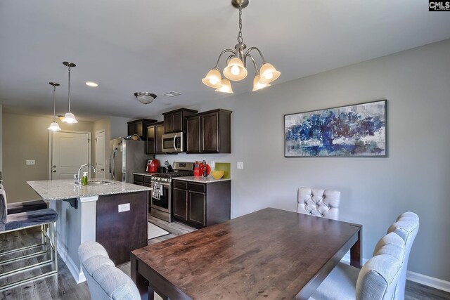 171 Turnfield Dr, West Columbia, SC 29170 - dining room with wood finished floors, a chandelier, baseboards, and recessed lighting
