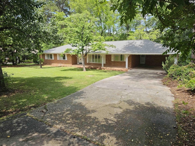 219 Tram Rd, Columbia, SC 29210 - single story home with a front lawn, driveway, a carport, and brick siding