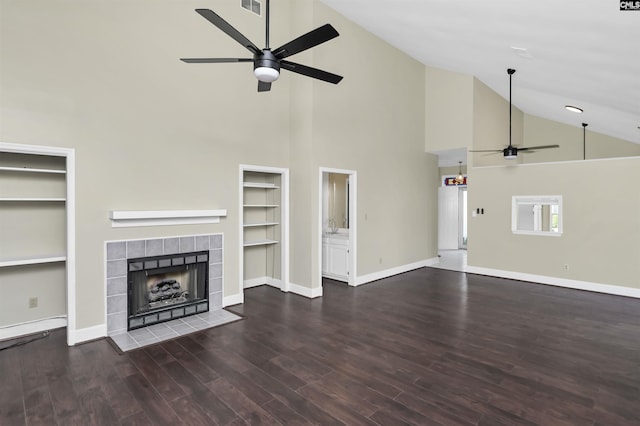 112 Gateway Ln, Columbia, SC 29210 - unfurnished living room with ceiling fan, high vaulted ceiling, a tile fireplace, wood finished floors, and built in features