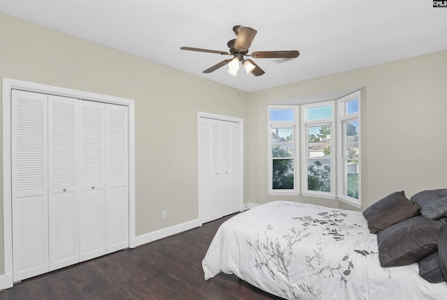 112 Gateway Ln, Columbia, SC 29210 - bedroom featuring multiple closets, dark wood finished floors, baseboards, and ceiling fan