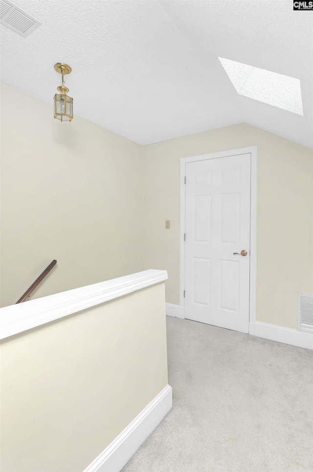 112 Gateway Ln, Columbia, SC 29210 - corridor with a skylight, an upstairs landing, light colored carpet, vaulted ceiling, and baseboards