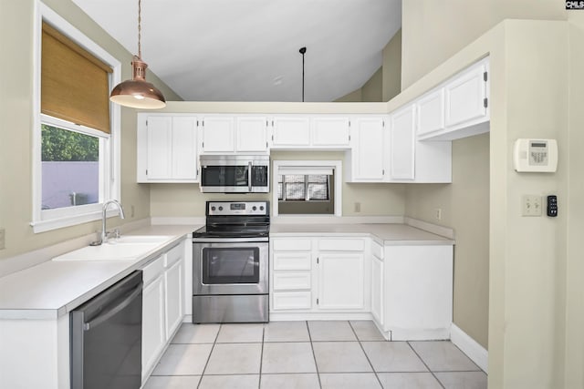112 Gateway Ln, Columbia, SC 29210 - kitchen featuring stainless steel appliances, a sink, lofted ceiling, light tile patterned floors, and white cabinetry