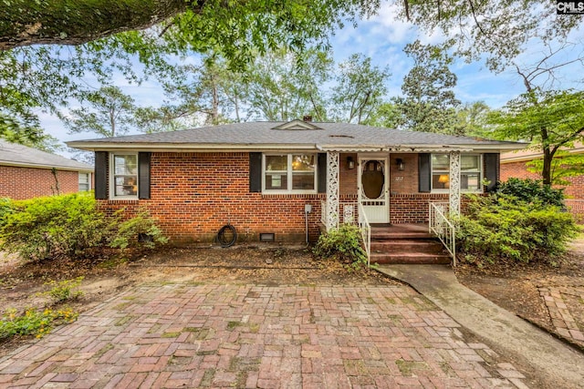 1217 Jensen St, West Columbia, SC 29169 - view of front of house with crawl space, brick siding, covered porch, and roof with shingles