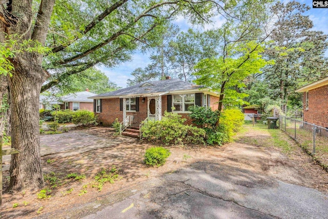 1217 Jensen St, West Columbia, SC 29169 - bungalow-style home featuring brick siding, fence, and a chimney