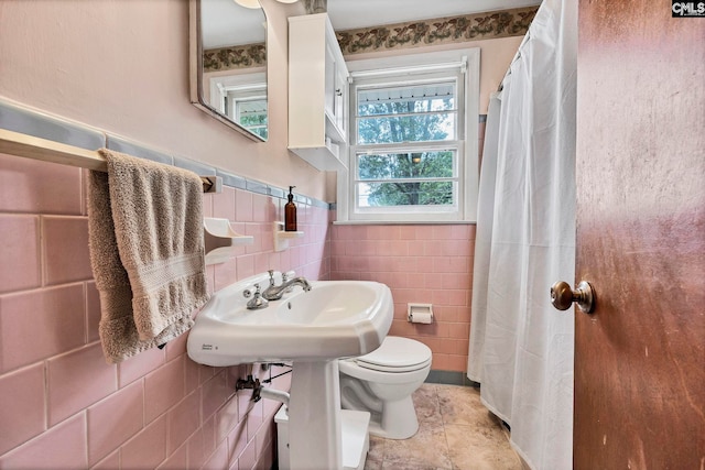 1217 Jensen St, West Columbia, SC 29169 - full bathroom featuring tile walls, toilet, tile patterned floors, and wainscoting