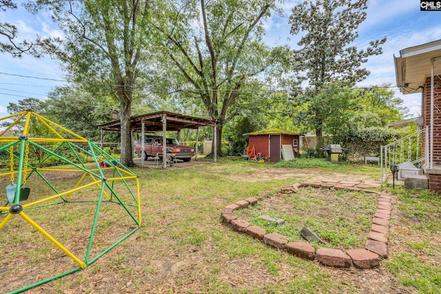 1217 Jensen St, West Columbia, SC 29169 - view of grassy yard featuring a storage unit, an outdoor structure, and a playground