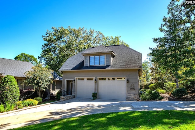 view of front of house with stone siding, driveway, a garage, and roof with shingles
