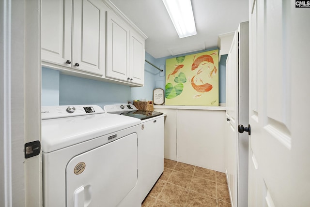 washroom with cabinet space and washing machine and dryer