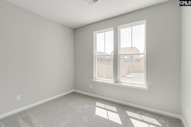 empty room with carpet floors and baseboards
