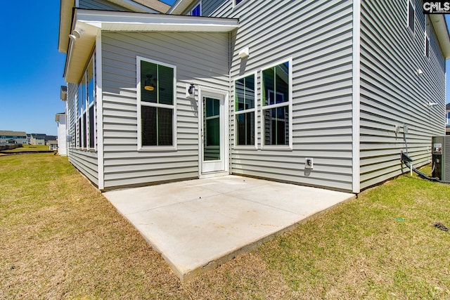 back of property featuring a yard, a patio area, and central AC unit