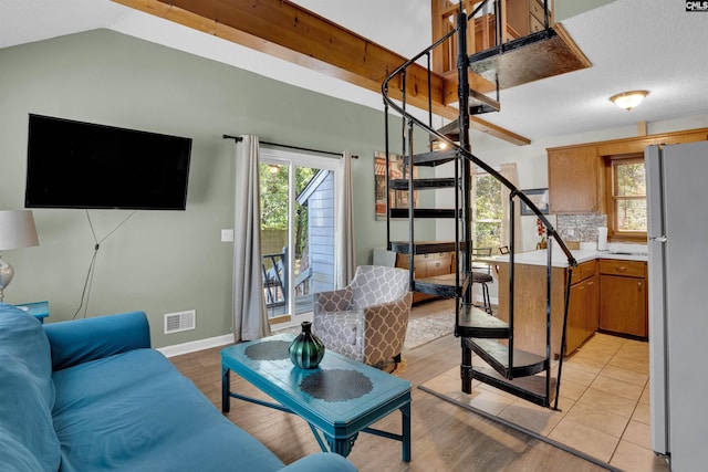 living room featuring stairs, light wood finished floors, and baseboards