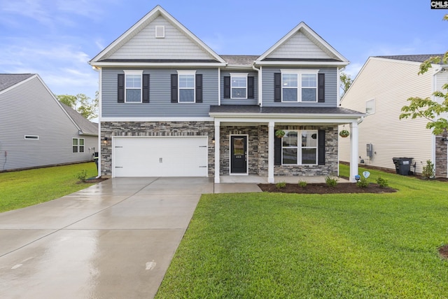 craftsman-style house with a front yard, driveway, an attached garage, and a porch