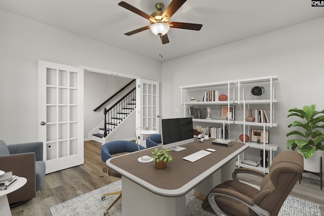 home office with ceiling fan, wood finished floors, and french doors
