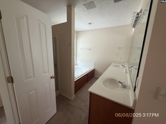 153 Berkeley Ridge Dr, Columbia, SC 29229 - bathroom featuring double vanity, a garden tub, tile patterned floors, and a textured ceiling