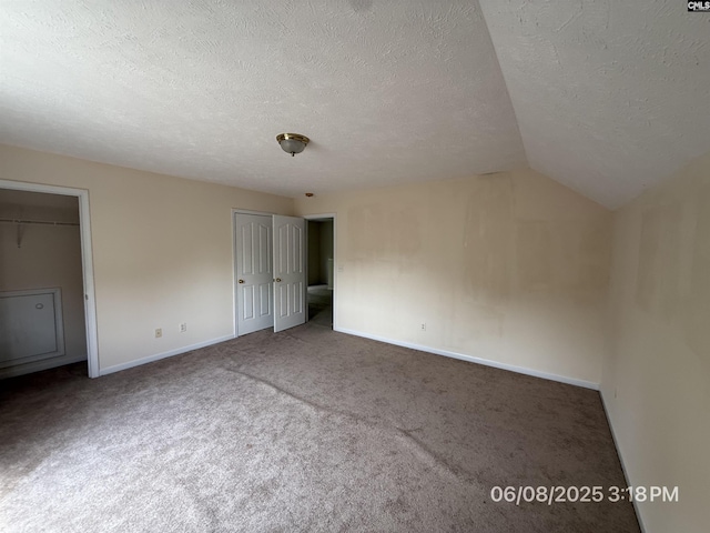 153 Berkeley Ridge Dr, Columbia, SC 29229 - unfurnished bedroom with a textured ceiling, carpet, vaulted ceiling, and two closets