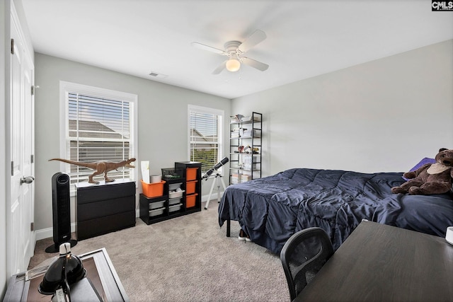carpeted bedroom featuring ceiling fan and baseboards