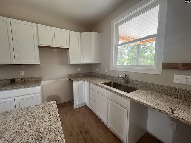 281 Osprey Pointe Ln, Prosperity, SC 29127 - kitchen with wood finished floors, white cabinetry, a sink, and light stone countertops