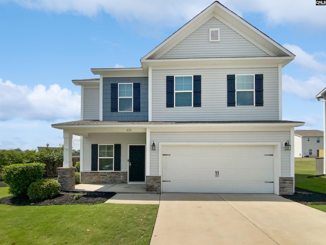 view of front of house with stone siding, driveway, an attached garage, and a front yard