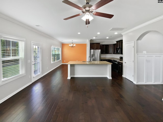 kitchen with stainless steel refrigerator with ice dispenser, a sink, crown molding, a chandelier, and dark wood finished floors