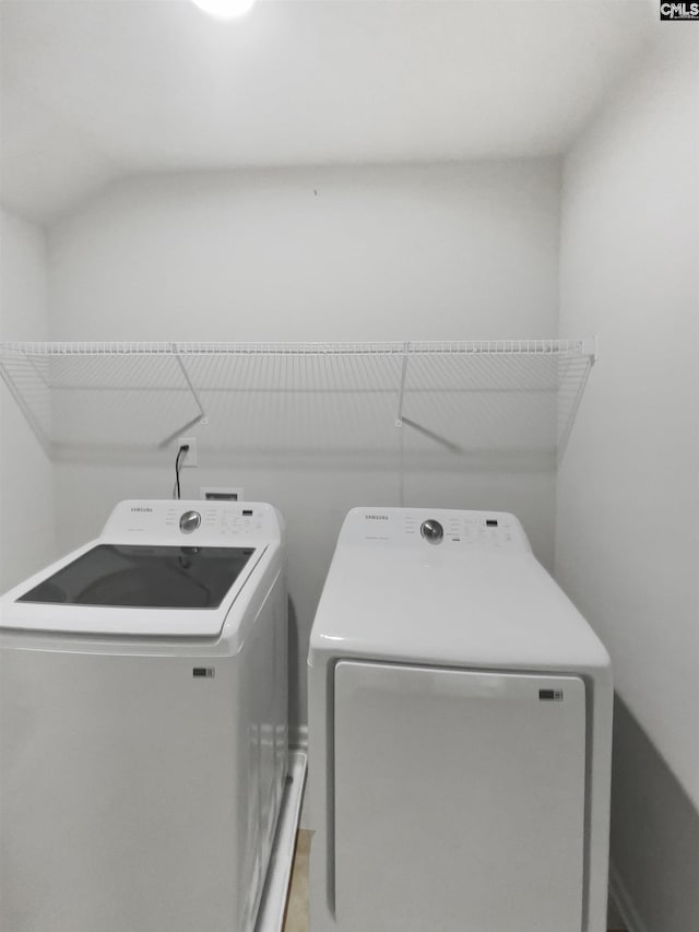 washroom with washing machine and clothes dryer