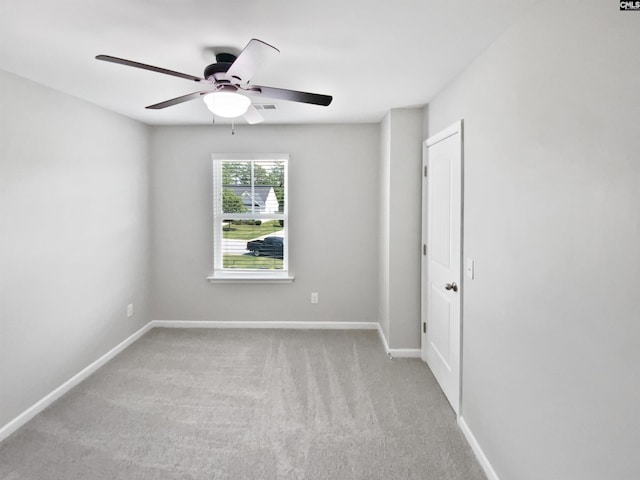 unfurnished room featuring ceiling fan, carpet flooring, and baseboards