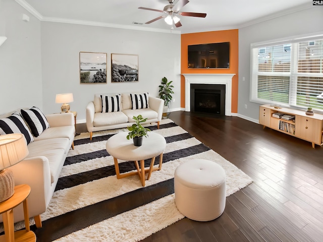 living room with a ceiling fan, crown molding, wood finished floors, a fireplace with flush hearth, and baseboards