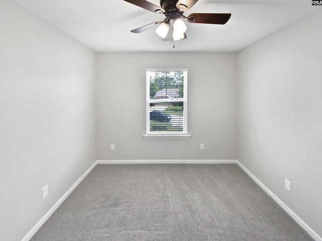 unfurnished room with carpet, a ceiling fan, and baseboards