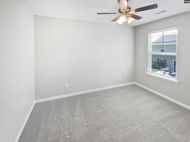 unfurnished room with a ceiling fan, carpet, and baseboards