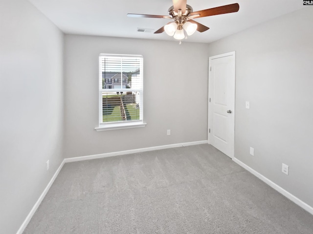 spare room with ceiling fan, carpet floors, and baseboards