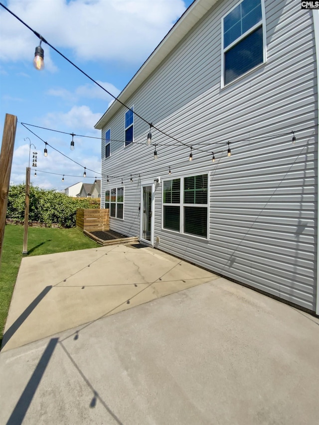 back of property featuring a patio area and a yard