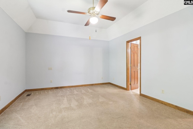empty room with a ceiling fan, light colored carpet, and baseboards