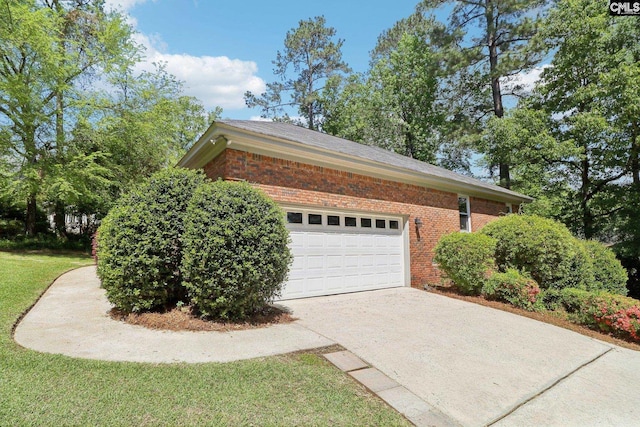 view of home's exterior featuring brick siding, driveway, and an attached garage