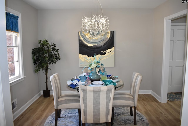 813 Greenlawn Dr, Columbia, SC 29209 - dining room featuring a chandelier, wood finished floors, and baseboards