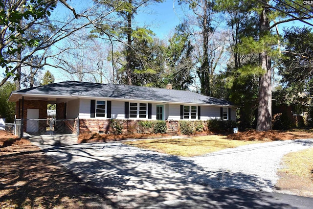 813 Greenlawn Dr, Columbia, SC 29209 - ranch-style house with gravel driveway, brick siding, fence, a carport, and a chimney