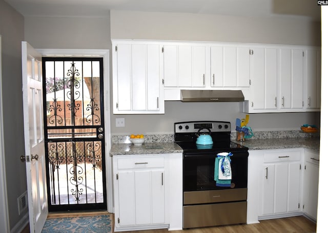 813 Greenlawn Dr, Columbia, SC 29209 - kitchen with stainless steel electric range oven, range hood, white cabinetry, and healthy amount of natural light