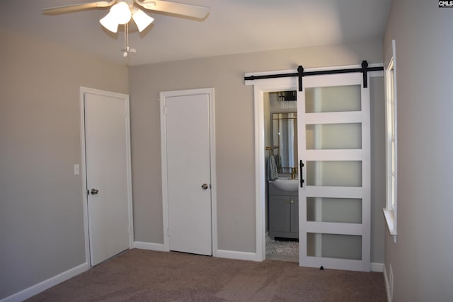 813 Greenlawn Dr, Columbia, SC 29209 - unfurnished bedroom with carpet floors, a barn door, baseboards, and ensuite bath