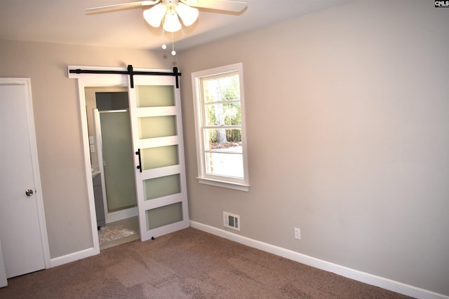 813 Greenlawn Dr, Columbia, SC 29209 - unfurnished bedroom featuring a barn door, carpet flooring, and baseboards