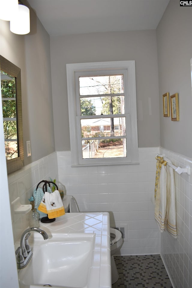 813 Greenlawn Dr, Columbia, SC 29209 - bathroom featuring a sink, tile walls, a wainscoted wall, and toilet