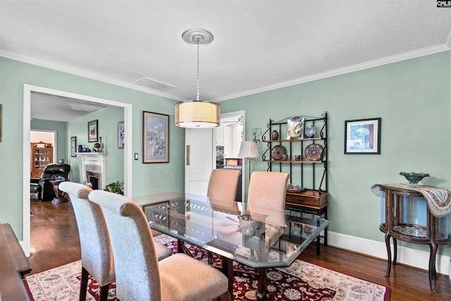 4833 Circle Dr, Columbia, SC 29206 - dining space featuring wood finished floors, ornamental molding, baseboards, a fireplace, and a textured ceiling