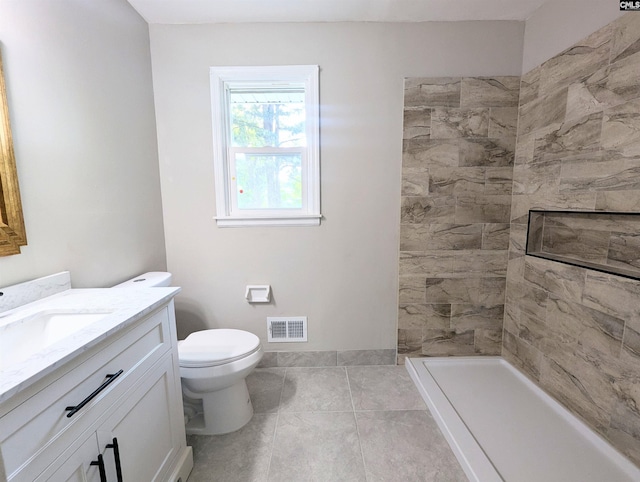 1921 Spotswood Dr, Columbia, SC 29210 - full bathroom featuring vanity, toilet, a tile shower, tile patterned flooring, and baseboards