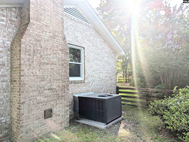 1921 Spotswood Dr, Columbia, SC 29210 - view of property exterior with brick siding, central AC, and fence