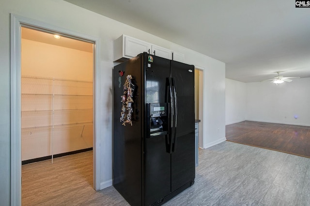 175 Nestle Ct, Columbia, SC 29209 - kitchen featuring black fridge with ice dispenser, white cabinetry, ceiling fan, and baseboards